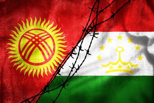 Grunge flags of Kyrgyzstan and Tajikistan divided by barb wire illustration, concept of tense relations between two countries