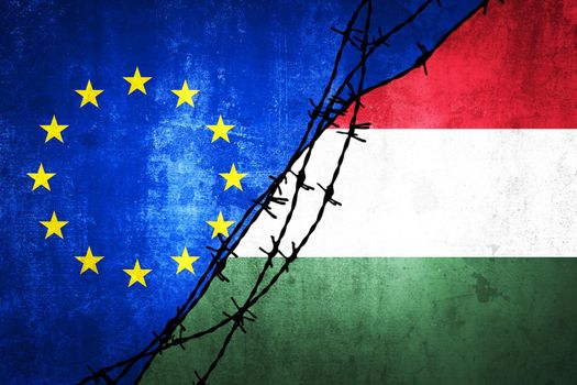 Grunge flags of EU and Hungary divided by barb wire illustration, concept of tense relations between and dispute of European union and Hungary