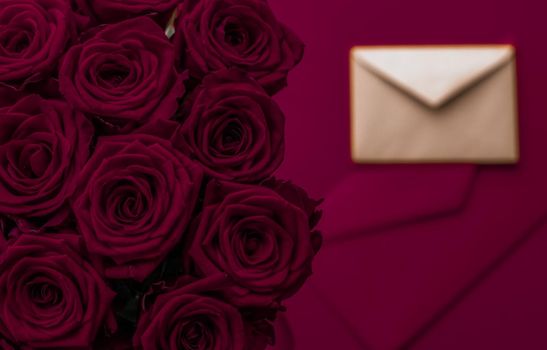 Holidays gift, floral present and happy relationship concept - Love letter and flowers delivery on Valentines Day, luxury bouquet of roses and card on maroon background for romantic holiday design