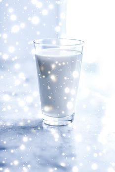 Dairy products, healthy diet and Christmas food concept - Magic holiday drink, pouring organic lactose free milk into glass on marble table