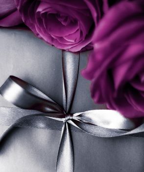 Luxurious design, shop sale promotion and happy surprise concept - Luxury holiday silver gift box and purple roses as Christmas, Valentines Day or birthday present