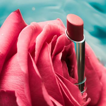 Cosmetic branding, luxe and fashion concept - Pink lipstick and rose flower on liquid background, waterproof glamour make-up and lip gloss cosmetics product for luxury beauty brand holiday design