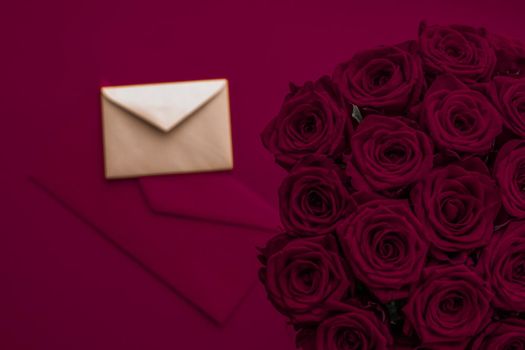 Holidays gift, floral present and happy relationship concept - Love letter and flowers delivery on Valentines Day, luxury bouquet of roses and card on maroon background for romantic holiday design