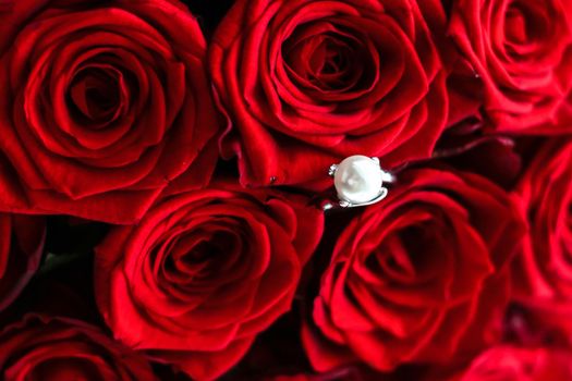 Gemstone jewellery, wedding present and engagement proposal concept - Beautiful white gold pearl ring and bouquet of red roses, luxury jewelry love gift on Valentines Day and romantic holidays