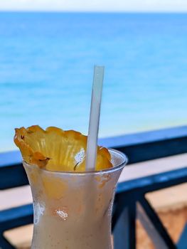 enjoying a dringk and a view of beach in oahu hawaii