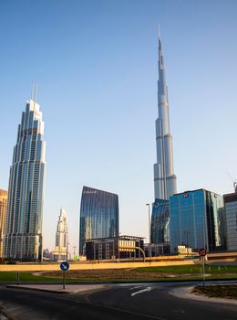 Dubai Financial Center road. Burj Khalifa tallest building in the world can be seen on the scene. Outdoors