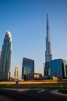 Dubai Financial Center road. Burj Khalifa tallest building in the world can be seen on the scene. Outdoors