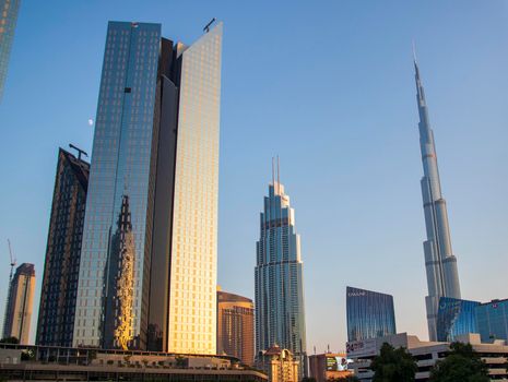 Towers in Dubai International Financial Center, Burj Khalifa, Tallest building in the world can be seen in the scene. Outdoors