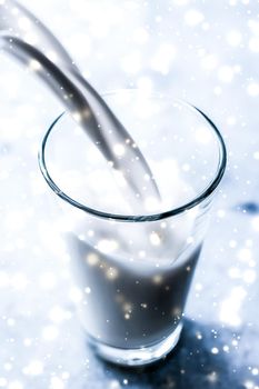 Dairy products, healthy diet and Christmas food concept - Magic holiday drink, pouring organic lactose free milk into glass on marble table