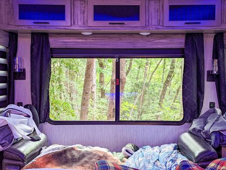 looking out the wndow of camper in the forest