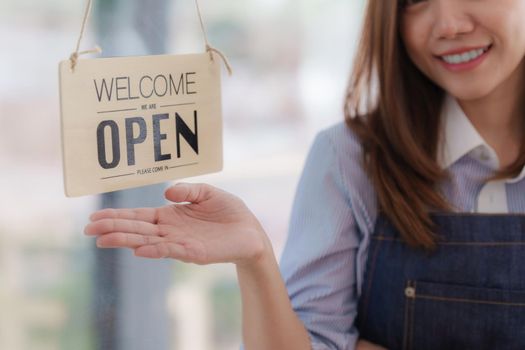 Asian Barista cafe owner smile while cafe open. SME entrepreneur seller business concept.