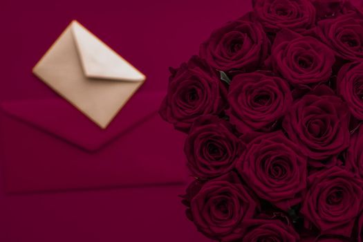 Holidays gift, floral present and happy relationship concept - Love letter and flowers delivery on Valentines Day, luxury bouquet of roses and card on maroon background for romantic holiday design