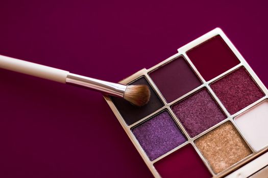 Cosmetic branding, mua and girly concept - Eyeshadow palette and make-up brush on wine background, eye shadows cosmetics product for luxury beauty brand promotion and holiday fashion blog design