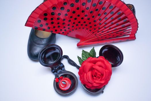 objects used in flamenco fan, castanets, high heel shoes and earrings on a white background