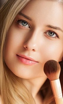 Make-up cosmetics and beauty product, beautiful woman applying cosmetic powder with organic bamboo makeup brush, face portrait close-up