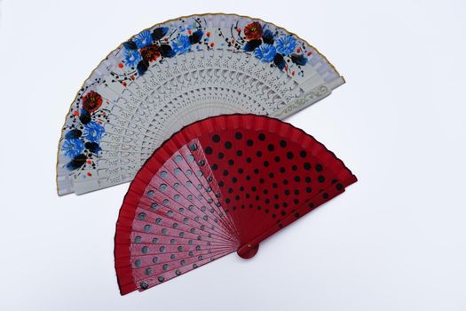 two hand painted handmade fans on white background
