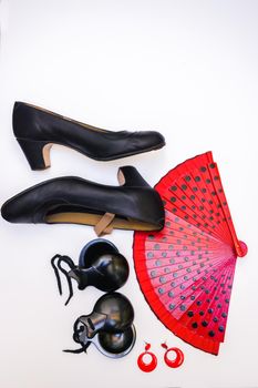 objects used in flamenco fan, castanets, high heel shoes and earrings on a white background