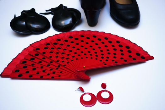 objects used in flamenco fan, castanets, high heel shoes and earrings on a white background