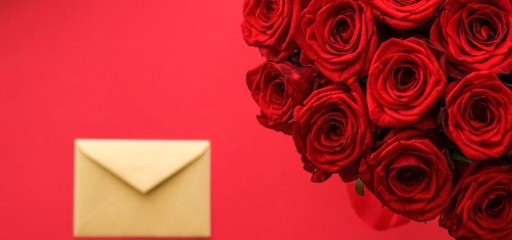 Holiday gift, flowers flatlay and happy relationship concept - Love letter and flower delivery service on Valentines Day, luxury bouquet of red roses and card envelopes on red background