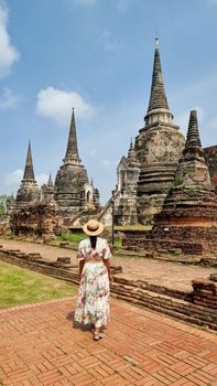 Women with hat tourist visit, Ayutthaya, Thailand at Wat Chaiwatthanaram during sunset in Ayutthaya Thailand