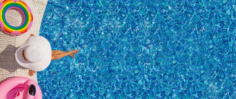 Child Splashes water in the pool. Selective focus. Kid.