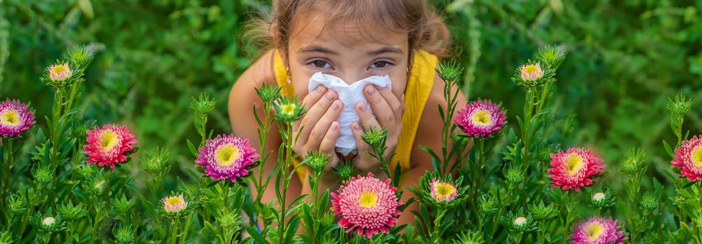 The child is seasonal allergy to flowers. Selective focus. Kid.