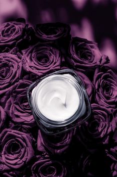 Luxe cosmetics, branding and anti-age concept - Face cream skin moisturizer on purple roses flowers, luxury skincare cosmetic product on floral background as beauty brand holiday flatlay design