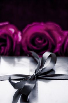 Luxurious design, shop sale promotion and happy surprise concept - Luxury holiday silver gift box and purple roses as Christmas, Valentines Day or birthday present