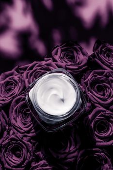 Luxe cosmetics, branding and anti-age concept - Face cream skin moisturizer on purple roses flowers, luxury skincare cosmetic product on floral background as beauty brand holiday flatlay design