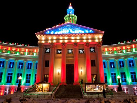 Downtown Denver at Christmas. Denver's City and County building decorated with holiday lights.