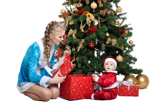 Beauty christmas girl in blue cloth play with baby santa claus near tree and gifts