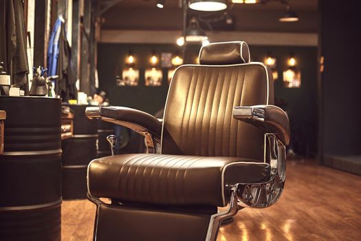 Close up brown leather chair in barbershop. Loft style