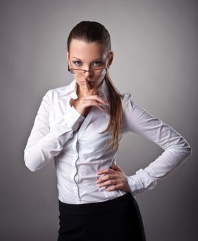 Sexy business woman silence sign look at camera