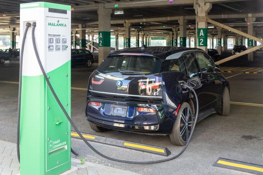 Grodno, Belarus - September 09, 2022: BMW i3 on 50kW fast charging spot Malanka on parking of the Triniti shoping mall - Car sharing commuter charging station. Charging technology industry transport which are the futuristic of the Automobile.