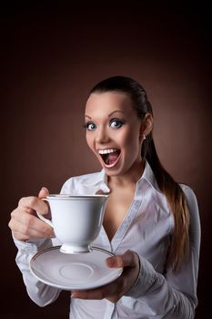 funny beauty woman with cup of coffee smile at brown background