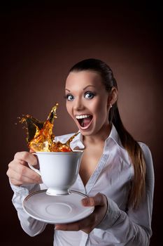funny young Woman with cup and splash of tea smile