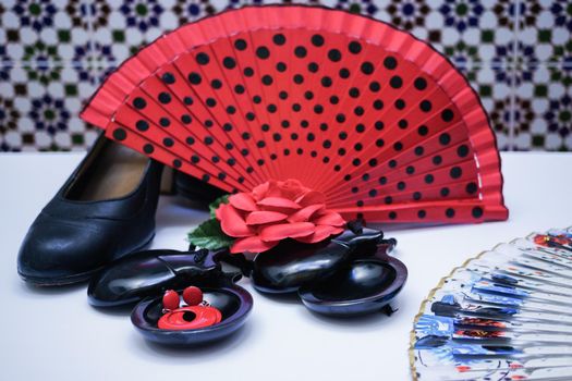 objects used in flamenco fan, castanets, high heel shoes and earrings on a white background