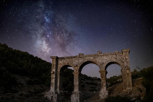 The ancient city of Ariassos, the city gate in a night when the Milky Way is visible