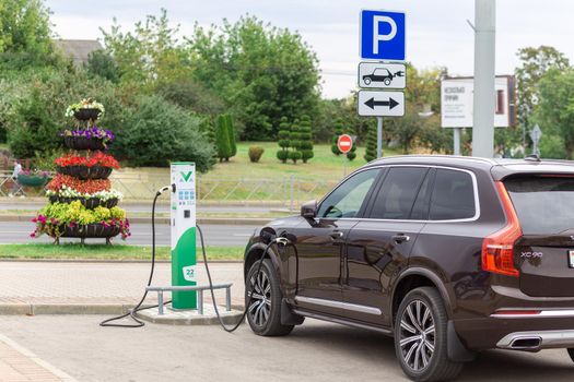Grodno, Belarus - September 09, 2022: Volvo CX90 on 22kW charging spot Malanka on Gorkogo st. - Car sharing commuter charging station. Charging technology industry transport which are the futuristic of the Automobile.