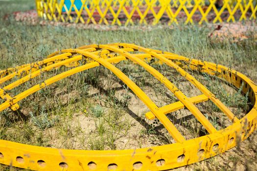 Shanyrak or shangyrak, wooden details of the Asian turkic yurt lie on the ground. Assembling the yurt in Kazakhstan steppe.