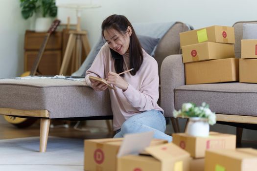 Asian SME business woman working at home office. online shopping concept.