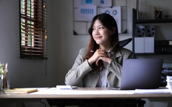 Asian business woman working in office with laptop paper work, Business woman concept..