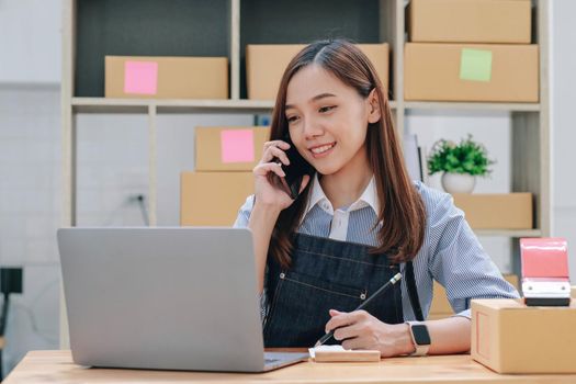 Startup small business entrepreneur SME, asian woman receive order on phone. Portrait young Asian small business owner home office, online sell marketing delivery