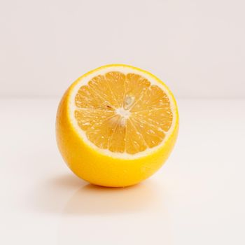 Juicy fresh cut lemon on the white background.