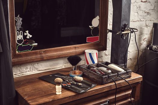 Barbershop tools on wooden brown table. Accessories for shaving and haircuts on the table. Still life