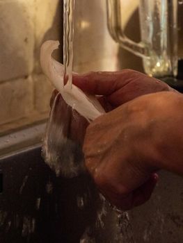 cleaning a raw adriatic cuttlefish at home in Numana, Marche, Italy