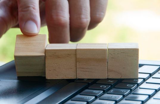 Finger flipping a wooden block with customizable space for text or ideas. Copy space.