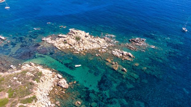 An amazing aerial view of the Sardinian coast. The wonderful colors of the sea contrast with the colors of the rocks.