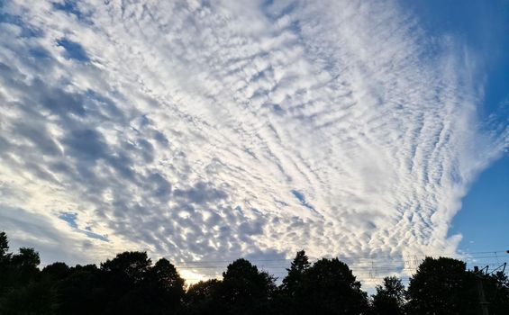 Beautiful fluffy white beautiful cloud formations in a deep blue summer sky