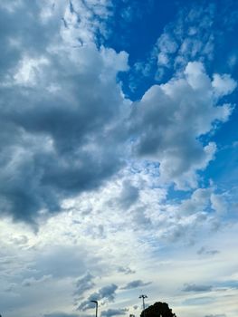 Beautiful fluffy white beautiful cloud formations in a deep blue summer sky